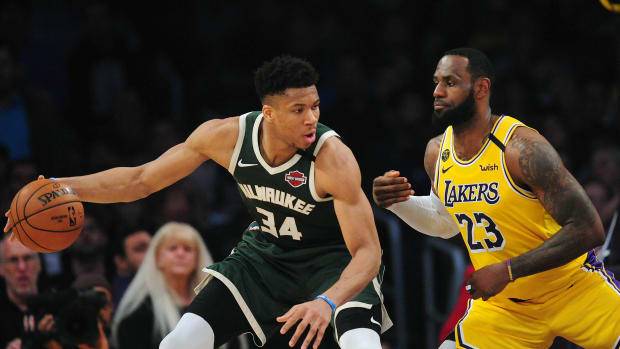 March 6, 2020; Los Angeles, California, USA; Milwaukee Bucks forward Giannis Antetokounmpo (34) controls the ball against Los Angeles Lakers forward LeBron James (23) during the first half at Staples Center. Mandatory Credit: Gary A. Vasquez-USA TODAY Sports